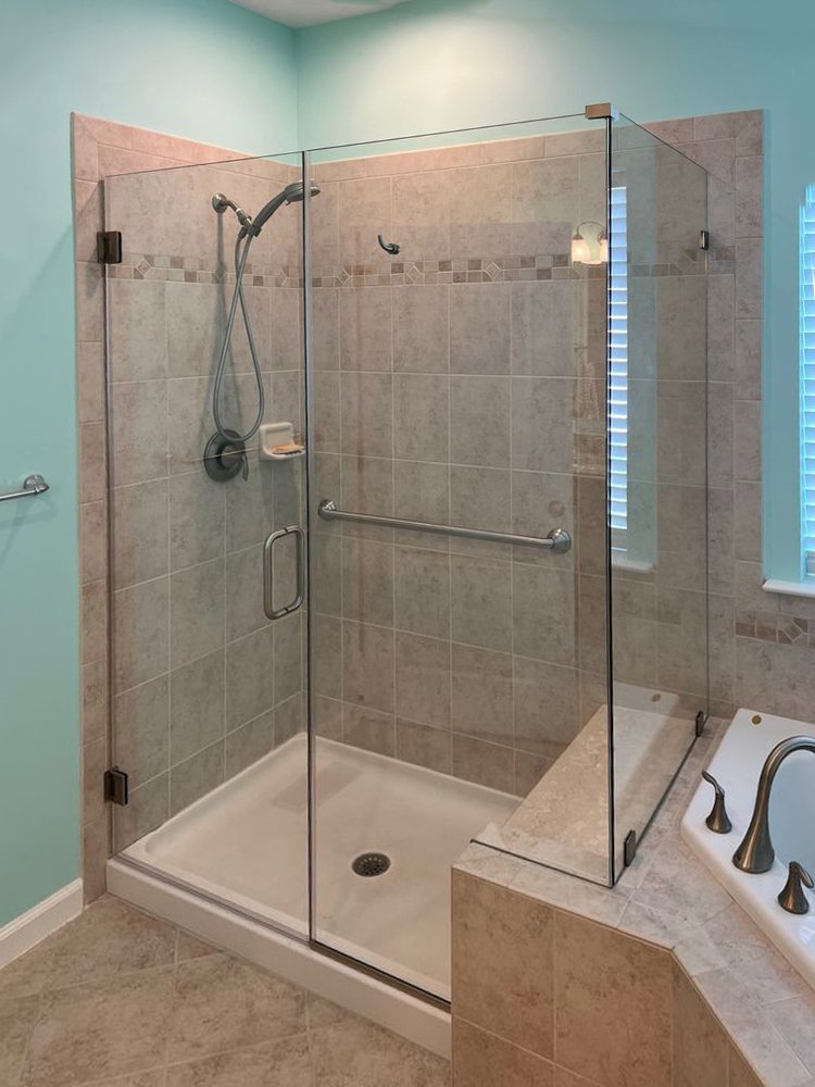 Frameless three-piece glass enclosure in the same shower, after replacement