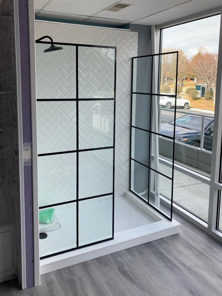 Shower glass with a matte black grid pattern next to a large window